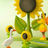 Bumbu handcrafted wooden festive goose decorative figure standing next to a wooden sunflowers child figure
