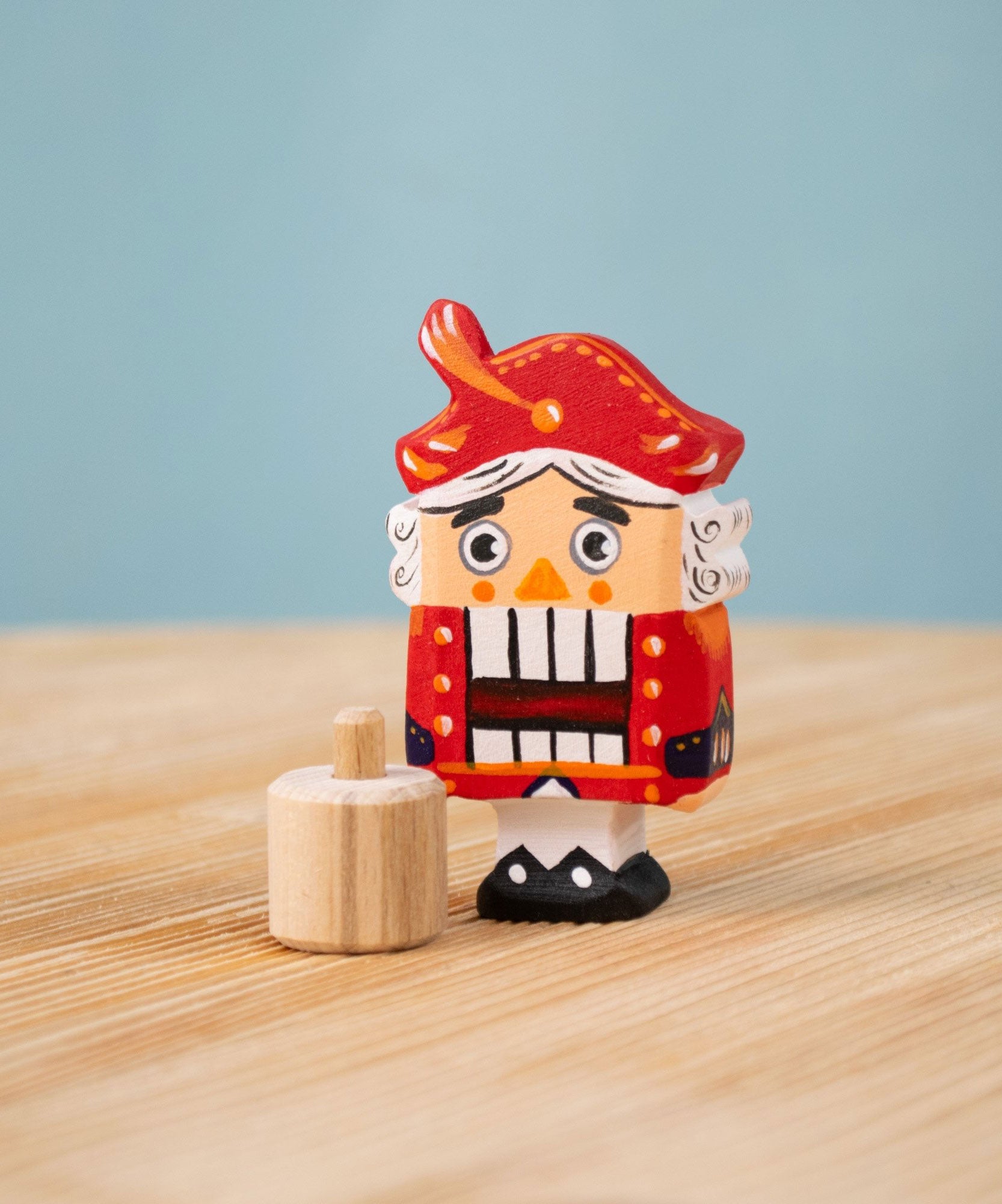 Bumbu red Festive Nutcracker Celebration decorative Figure to fit on a Grimm's celebration ring. These festive figures are perfect for your Christmas celebration ring set up. These expertly hand crafted items are part of a large range of wooden toys available here at Babipur. 