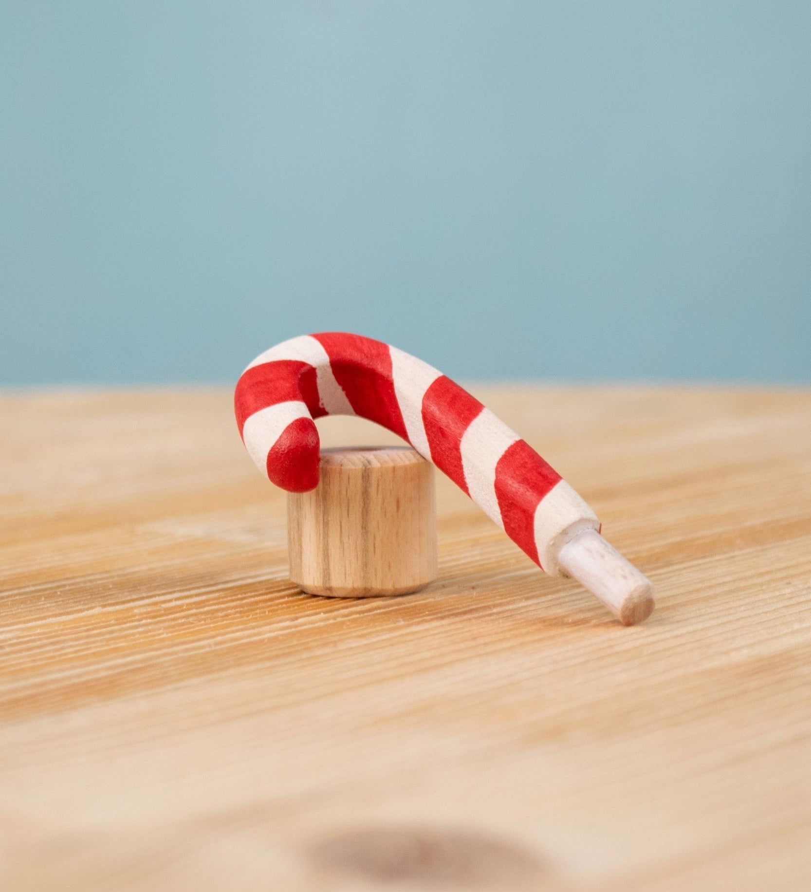 Bumbu red and white Festive Candy Cane Celebration ring decorative Figure to fit on a Grimm's celebration ring. These festive figures are perfect for your Christmas celebration ring set up. These expertly hand crafted items are part of a large range of wooden toys available here at Babipur. 