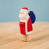 Bumbu red Festive Santa Celebration decorative Figure to fit on a Grimm's celebration ring. These festive figures are perfect for your Christmas celebration ring set up. These expertly hand crafted items are part of a large range of wooden toys available here at Babipur. 