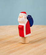 Bumbu red Festive Santa Celebration decorative Figure to fit on a Grimm's celebration ring. These festive figures are perfect for your Christmas celebration ring set up. These expertly hand crafted items are part of a large range of wooden toys available here at Babipur. 