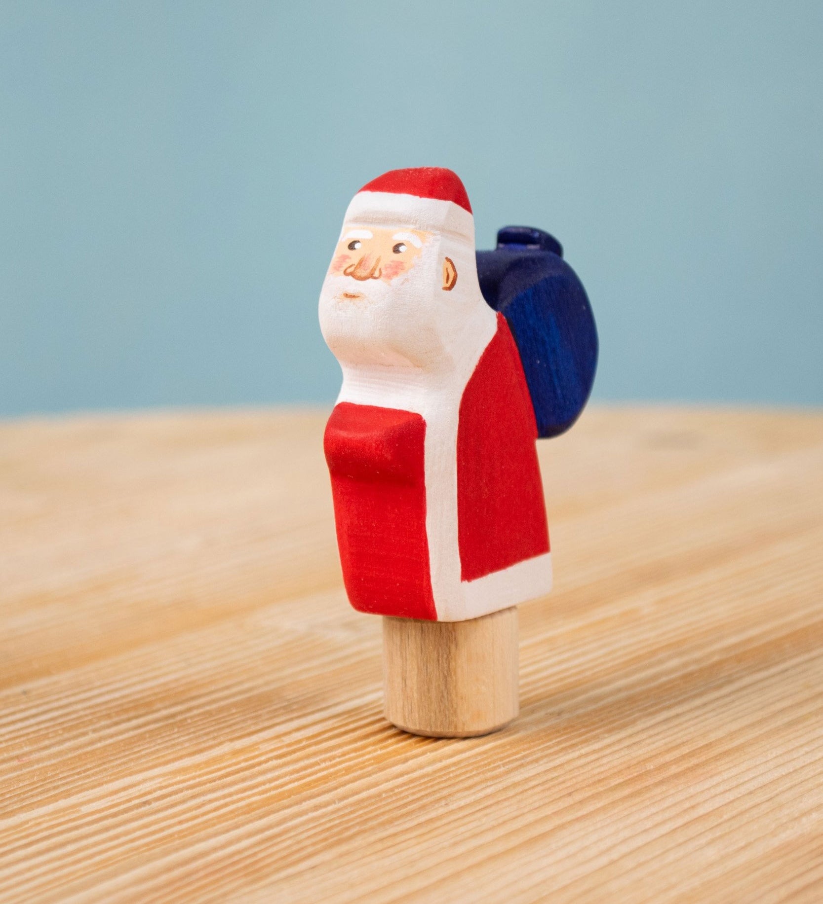 Bumbu red Festive Santa Celebration decorative Figure to fit on a Grimm's celebration ring. These festive figures are perfect for your Christmas celebration ring set up. These expertly hand crafted items are part of a large range of wooden toys available here at Babipur. 