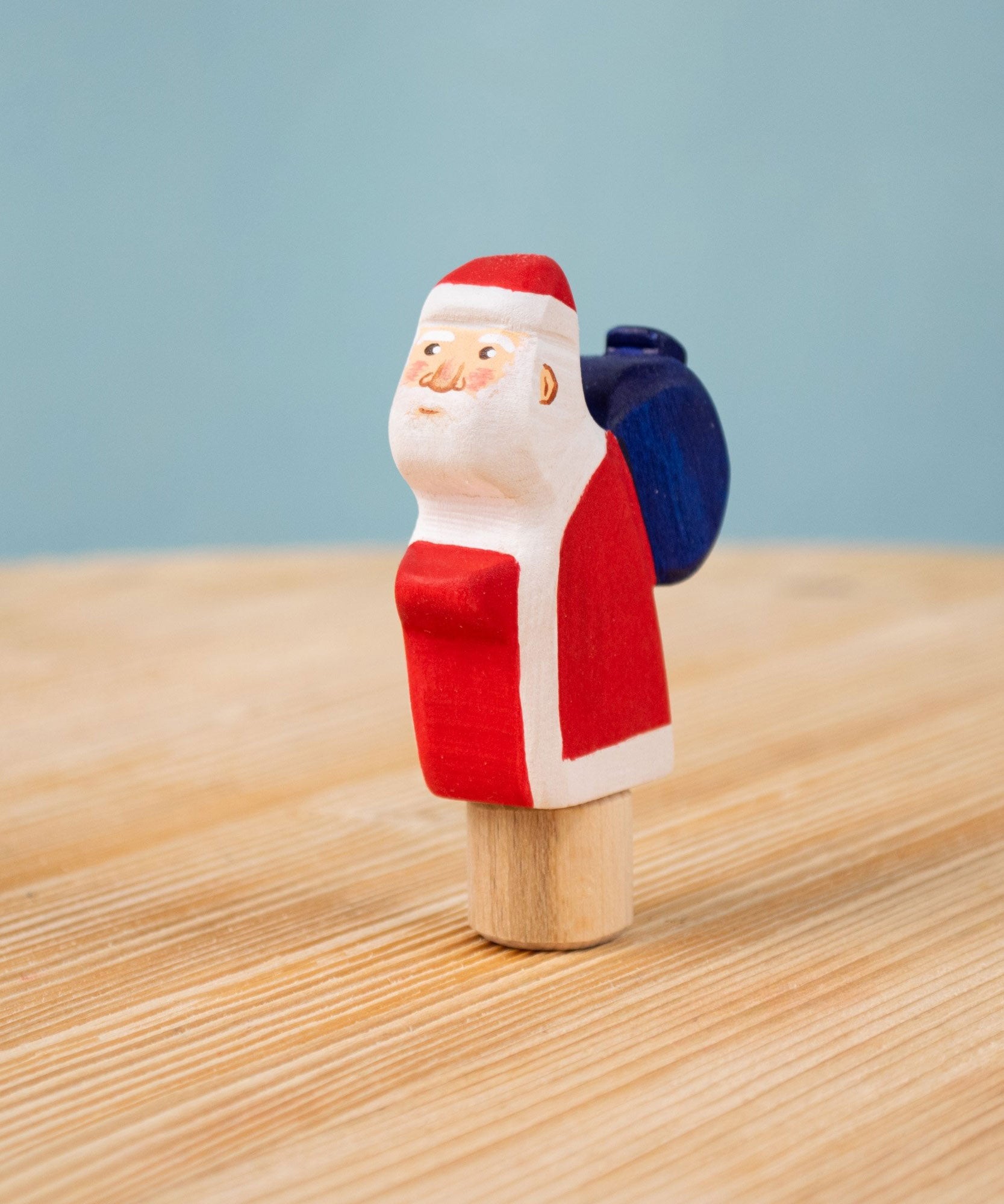 Bumbu red Festive Santa Celebration decorative Figure to fit on a Grimm's celebration ring. These festive figures are perfect for your Christmas celebration ring set up. These expertly hand crafted items are part of a large range of wooden toys available here at Babipur. 