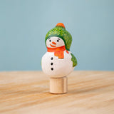 Bumbu Festive Snowman Celebration decorative Figure to fit on a Grimm's celebration ring. The handpainted snowman figure has a green hat with matching gloves and an orange scarf. These festive figures are perfect for your Christmas celebration ring set up. These expertly hand crafted items are part of a large range of wooden toys available here at Babipur.  