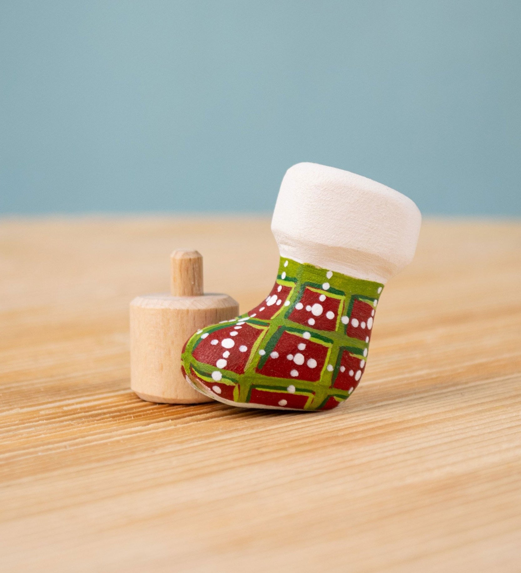 Bumbu red and green Festive Christmas Stocking Celebration decorative Figure to fit on a Grimm's celebration ring. These festive figures are perfect for your Christmas celebration ring set up. These expertly hand crafted items are part of a large range of wooden toys available here at Babipur. 