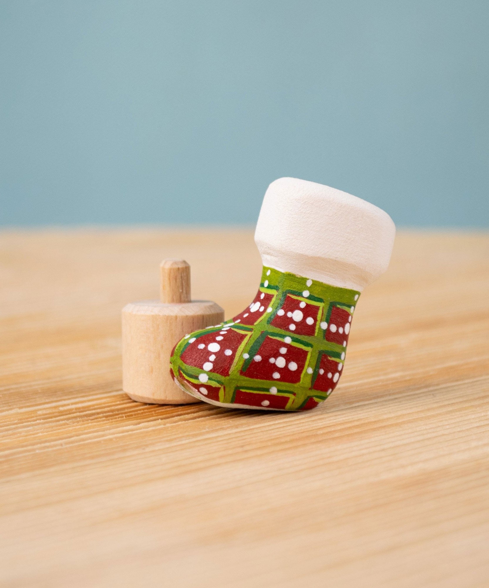 Bumbu red and green Festive Christmas Stocking Celebration decorative Figure to fit on a Grimm's celebration ring. These festive figures are perfect for your Christmas celebration ring set up. These expertly hand crafted items are part of a large range of wooden toys available here at Babipur. 