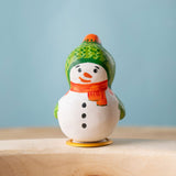 Bumbu Festive Snowman Celebration decorative Figure to fit on a Grimm's celebration ring. The handpainted snowman figure has a green hat with matching gloves and an orange scarf. These festive figures are perfect for your Christmas celebration ring set up. These expertly hand crafted items are part of a large range of wooden toys available here at Babipur.  