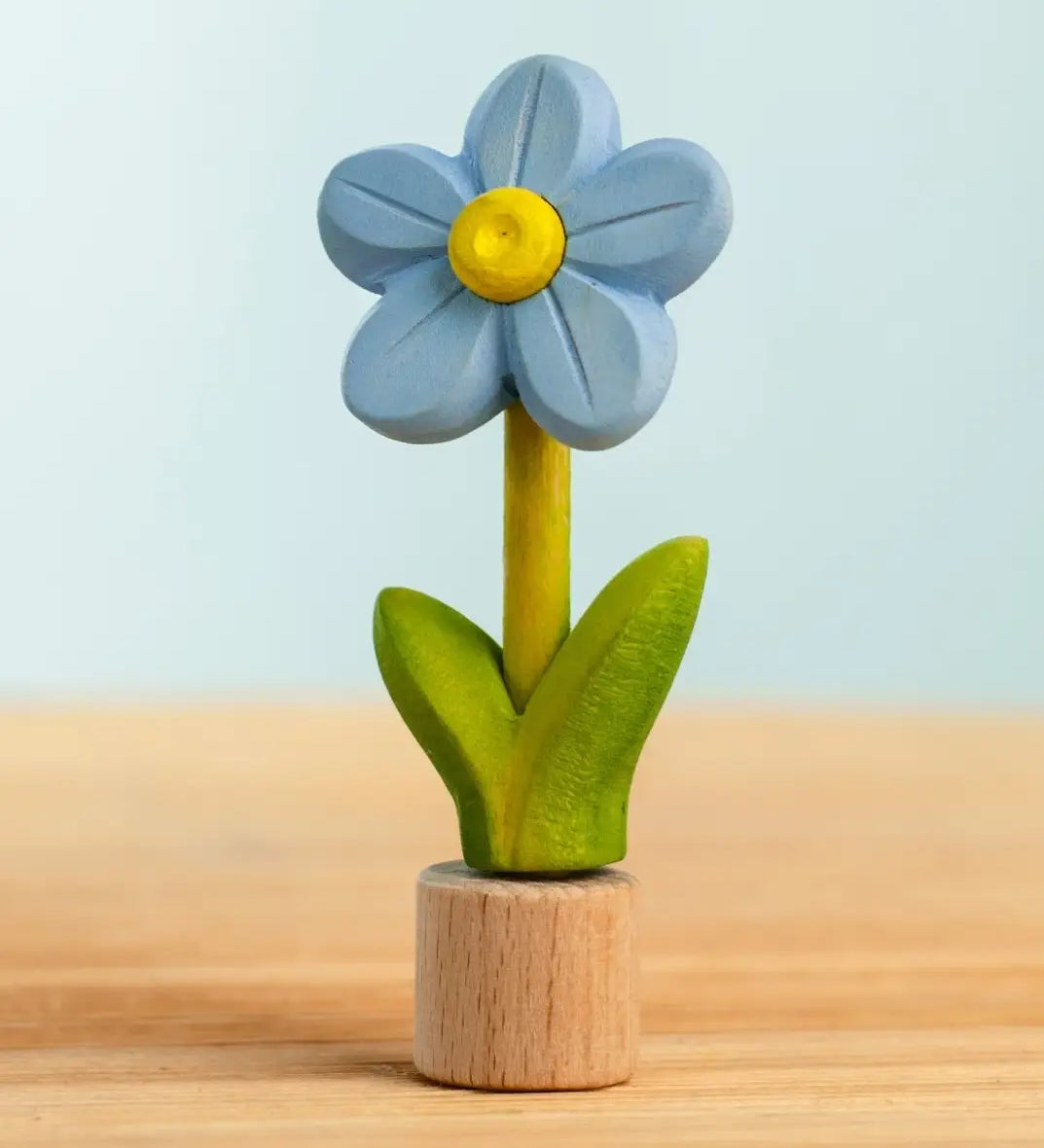 Bumbu handcrafted wooden blue festive forget me not figure standing on wooden base for Grimms celebration ring