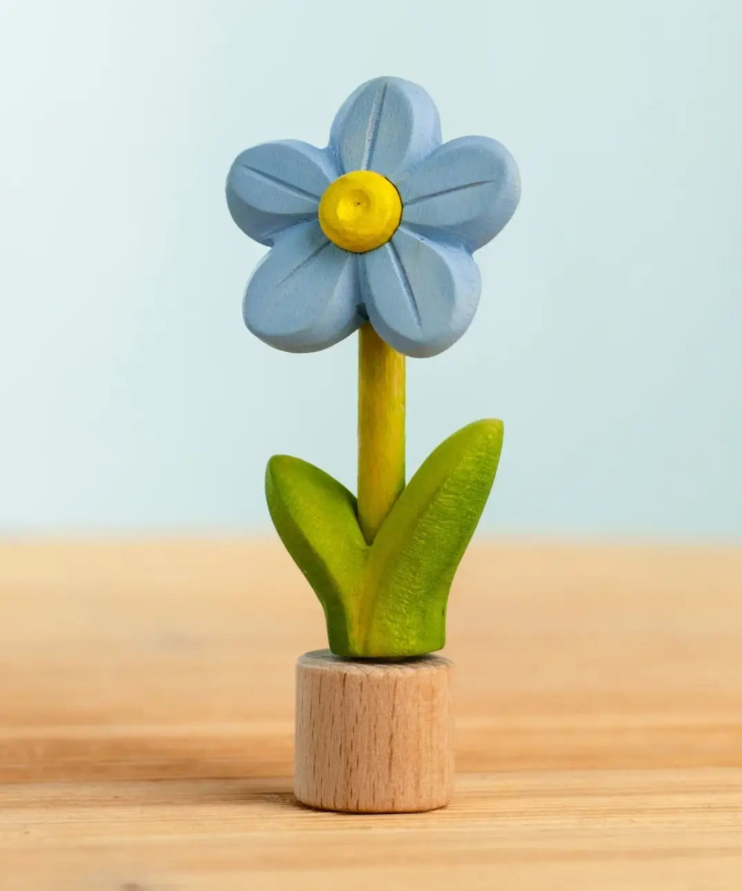 Bumbu handcrafted wooden blue festive forget me not figure standing on wooden base for Grimms celebration ring