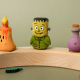 Bumbu handcrafted wooden Frankenstein decorative figure displayed on a celebration ring piece next to other halloween figures