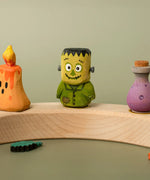 Bumbu handcrafted wooden Frankenstein decorative figure displayed on a celebration ring piece next to other halloween figures
