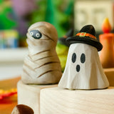 Bumbu ghost wizard decorative figure placed on a celebration ring with a mummy figure in the background. 