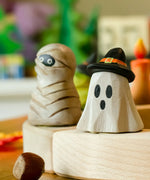 Bumbu ghost wizard decorative figure placed on a celebration ring with a mummy figure in the background. 