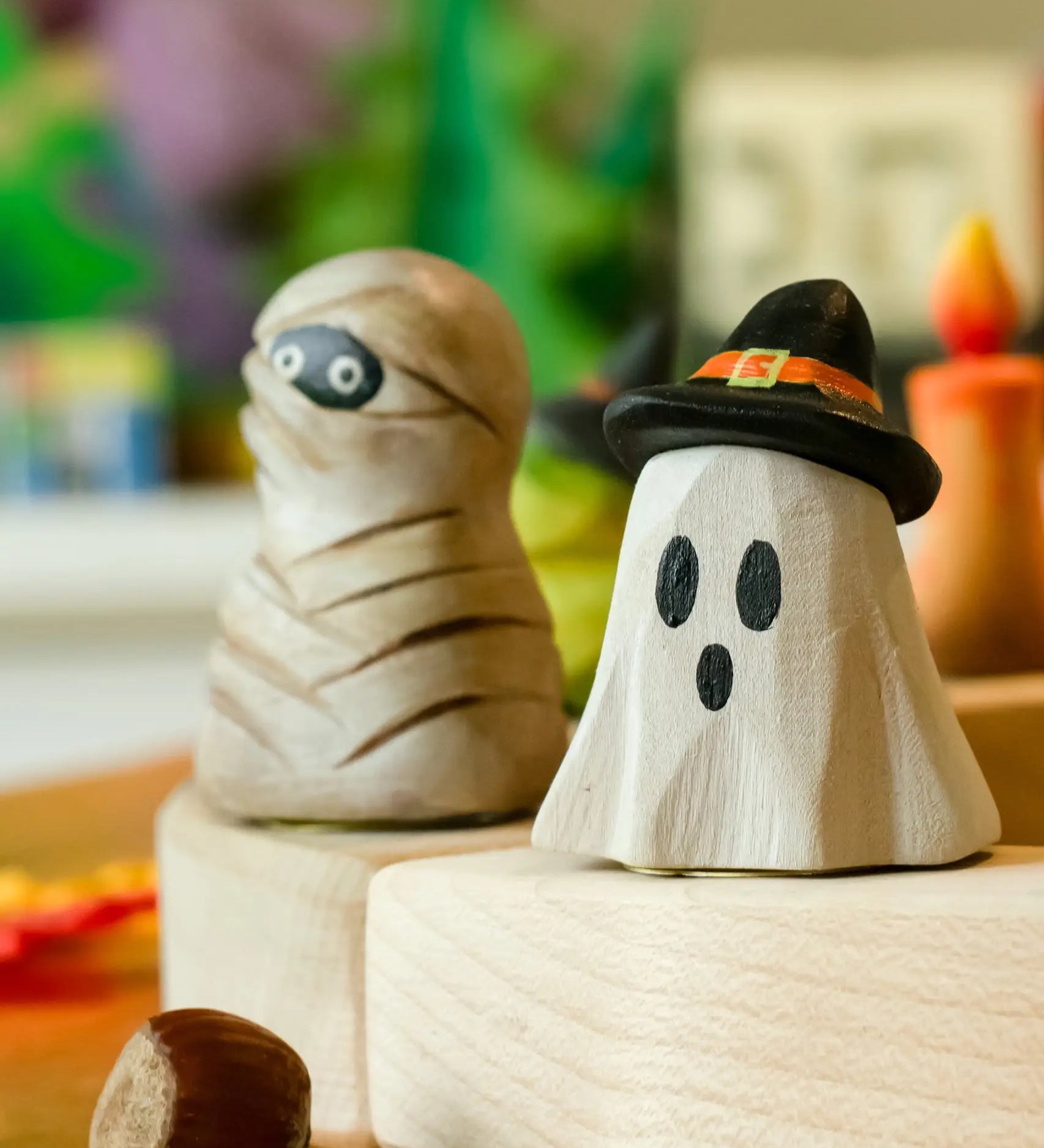 Bumbu ghost wizard decorative figure placed on a celebration ring with a mummy figure in the background. 