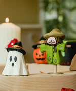 Bumbu ghost wizard and scarecrow decorative figures placed on a natural wooden celebration ring. 