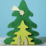 A Bumbu Christmas Tree Nativity Puzzle in the Gold colour way placed on a wooden surface. 