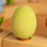 Bumbu wooden green egg decorative figure standing in a celebration ring