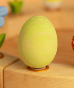 Bumbu wooden green egg decorative figure standing in a celebration ring