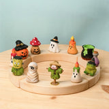 A celebration ring filled with different Bumbu wooden Halloween decorative figures 