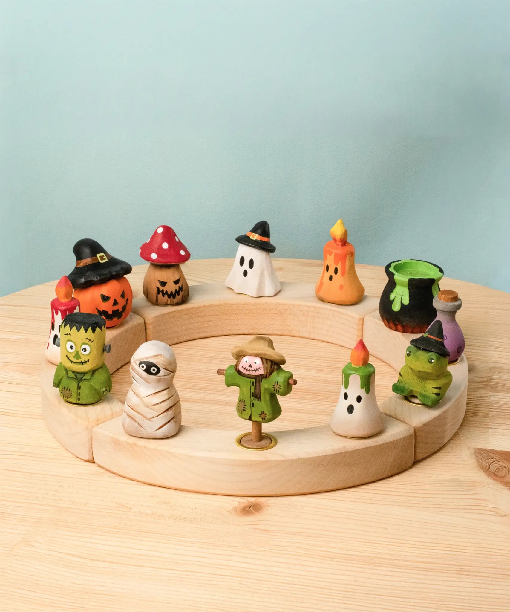 A celebration ring filled with different Bumbu wooden Halloween decorative figures 