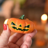 A large Bumbu wooden pumpkin figure shown in an adult's hand for scale. These wooden figures are part of a wide range of expertly hand crafted wooden toys here at Babipur. 