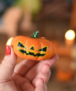 A large Bumbu wooden pumpkin figure shown in an adult's hand for scale. These wooden figures are part of a wide range of expertly hand crafted wooden toys here at Babipur. 