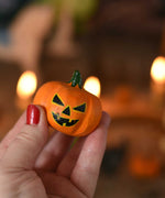 A medium Bumbu wooden pumpkin figure shown in an adult's hand for scale. These wooden figures are part of a wide range of expertly hand crafted wooden toys here at Babipur. 