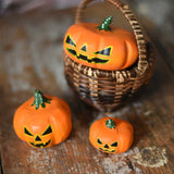 Bumbu Halloween pumpkins placed in and around a Kraul basket on a wooden surface. These wooden figures are part of a wide range of expertly hand crafted wooden toys here at Babipur. 