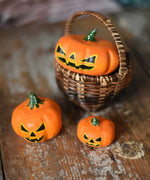 Bumbu Halloween pumpkins placed in and around a Kraul basket on a wooden surface. These wooden figures are part of a wide range of expertly hand crafted wooden toys here at Babipur. 