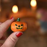 A small Bumbu wooden pumpkin figure shown in an adult's hand for scale. These wooden figures are part of a wide range of expertly hand crafted wooden toys here at Babipur. 