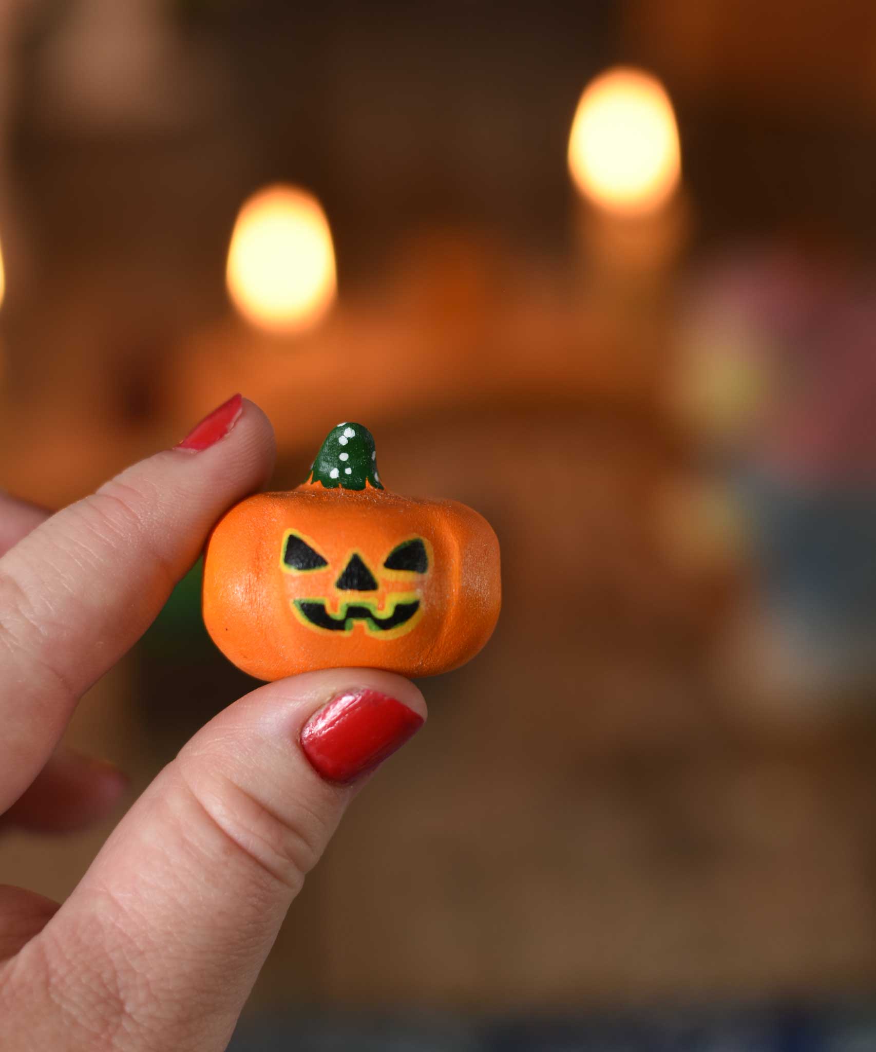 A small Bumbu wooden pumpkin figure shown in an adult's hand for scale. These wooden figures are part of a wide range of expertly hand crafted wooden toys here at Babipur. 