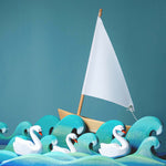 Bumbu Wooden Waves. The toy is paired with swans and a boat.