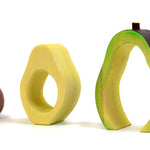 Pieces of the Bumbu eco-friendly wooden avocado waldorf toy lined up on a white background