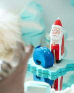Close up of a Bumbu Santa Claus toy stood on a Bumbu ice floe block
