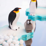 female and baby penguin wooden toy figures stood on a white background