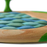 Close up of the wood textures on the sustainable Bumbu lake puzzle on a white background