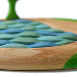 Close up of the wood textures on the sustainable Bumbu lake puzzle on a white background