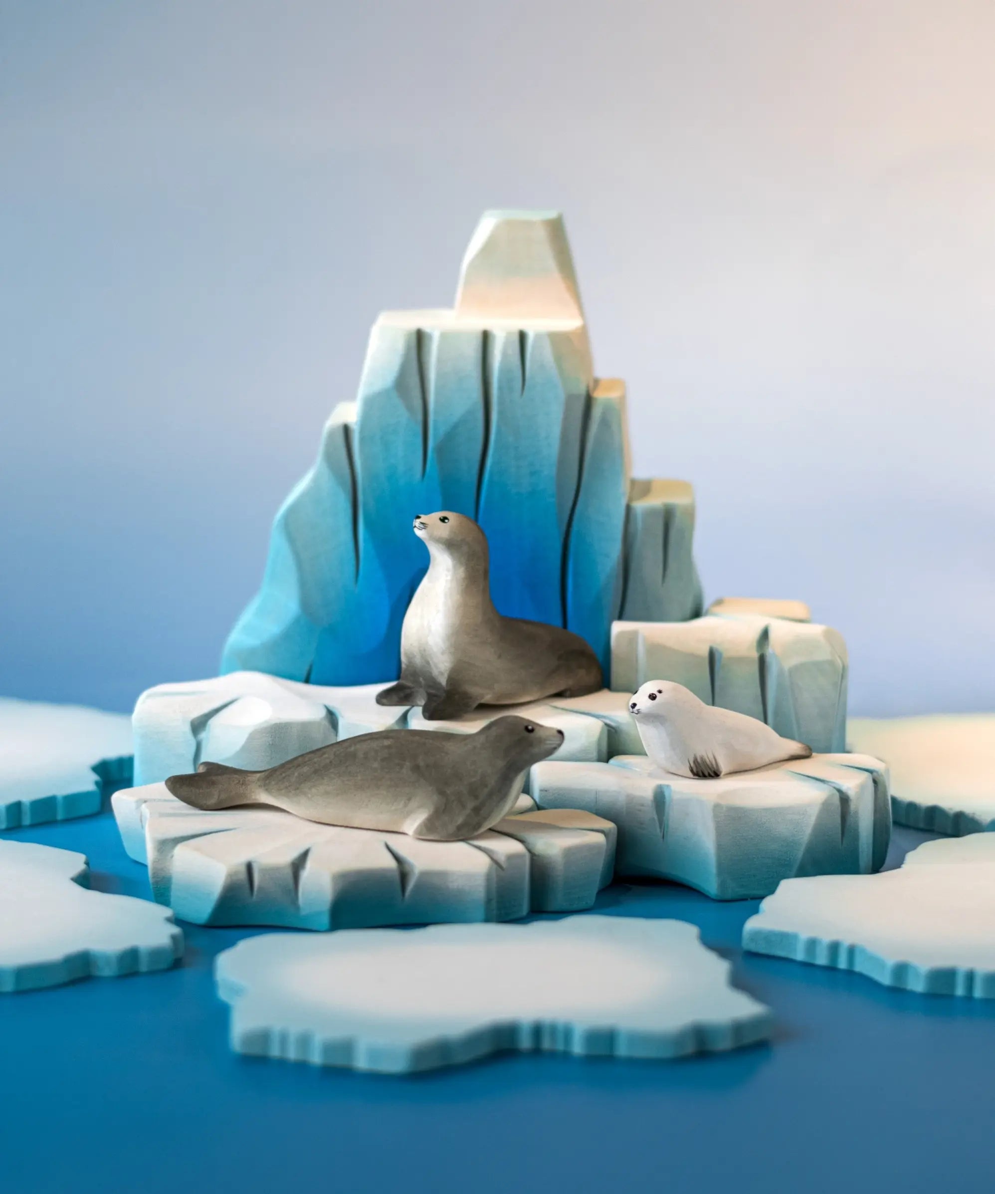 Bumbu Toys harp seal pup, curious harp seal and harp seal placed on an ice berg in a small world play scene. 