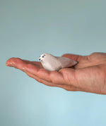 Bumbu Toys harp seal pup handmade wooden toy figure in an adult's hand.