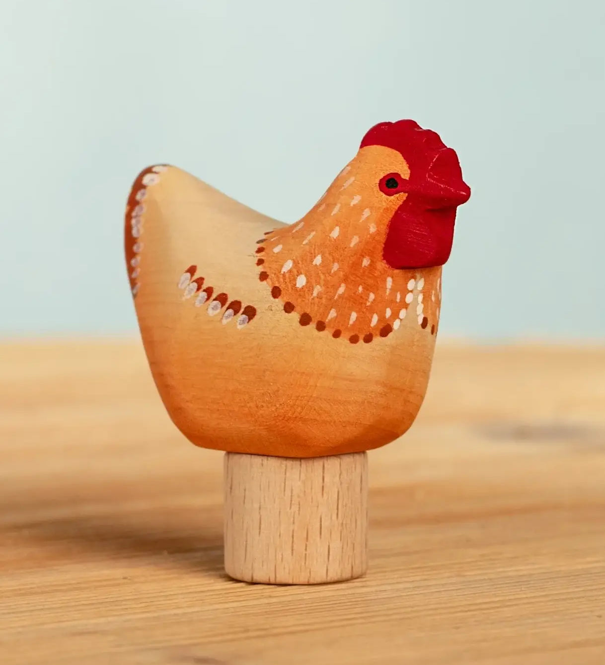 Bumbu handcrafted wooden brown festive hen figure standing on wooden base for Grimms celebration ring