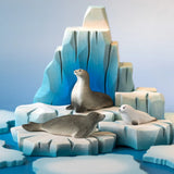 A winter play scene showing the Bumbu handcrafted wooden iceberg  and seal figures 