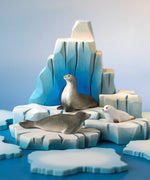 A winter play scene showing the Bumbu handcrafted wooden iceberg  and seal figures 