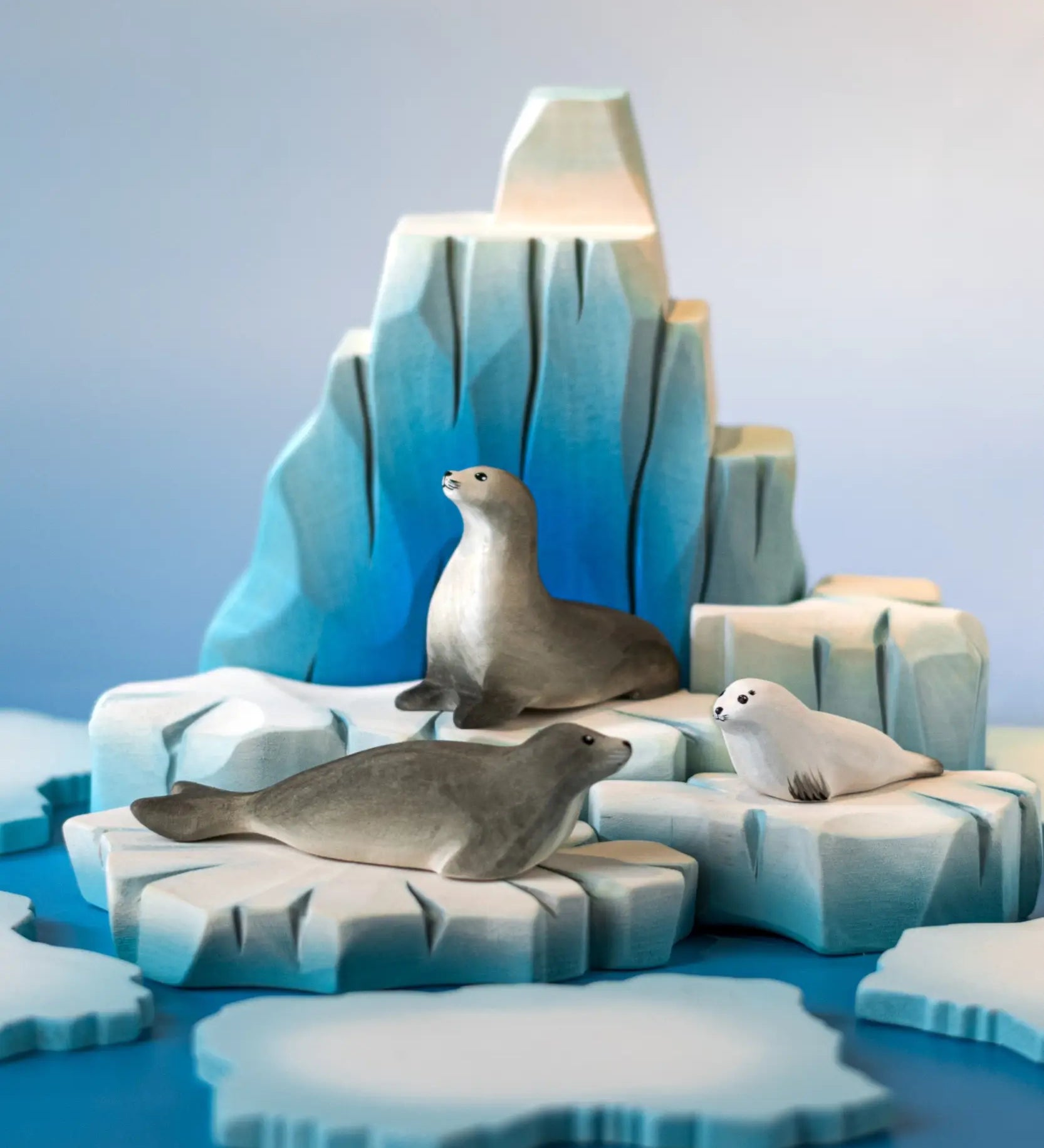 A winter play scene showing the Bumbu handcrafted wooden iceberg  and seal figures 