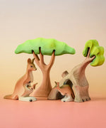 Bumbu Toys Mama Kangaroo & Joey figures set up in a small world lay scene along with other Bumbu toys.