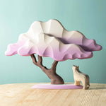 Bumbu purple winter Japanese maple tree toy on a wooden table next to a wooden wolf figure