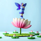 A Bumbu Heron and fish next to the Bumbu Large Wooden Lotus Flower. A pink and white Lotus Flower with a green stalk and green base