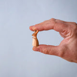 The little joey from the Bumbu Toys Mama Kangaroo & Joey figures set up shown in an adult's hand to show scale.