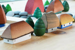Bumbu Muntenia handmade wooden houses on a wooden table next to some grapat mandala trees