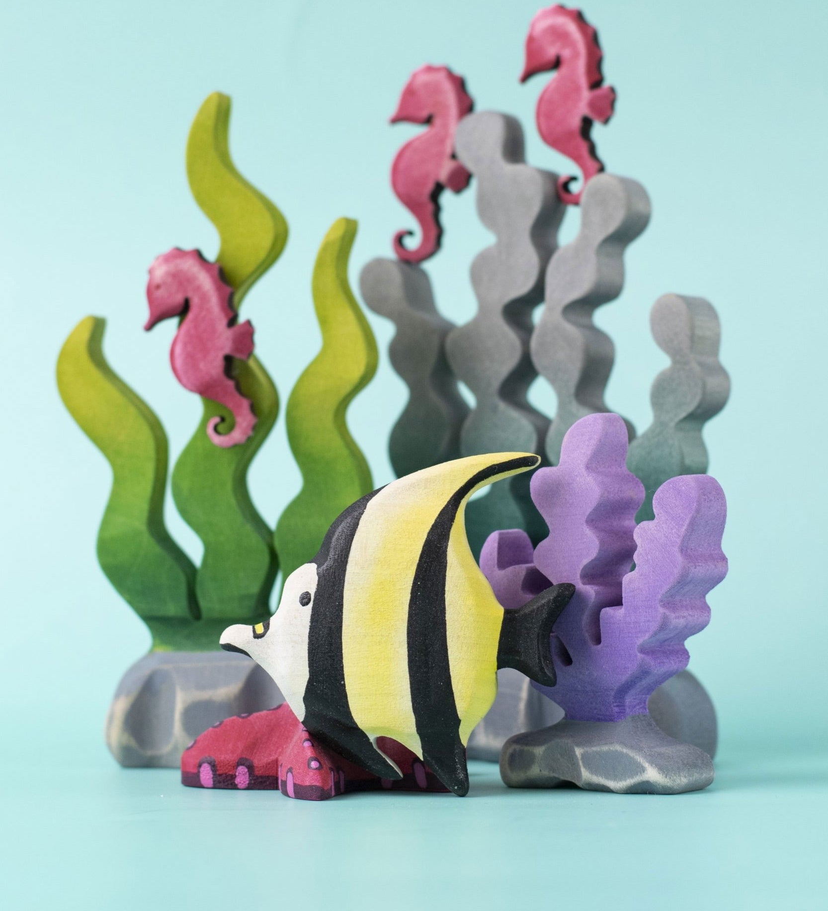 A Bumbu Toys Moorish Idol Fish placed at the front of an underwater themed small world play scene. 