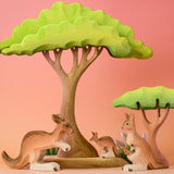 Bumbu Toys Mama Kangaroo & Joey figures set up in a small world lay scene along with other Bumbu toys.